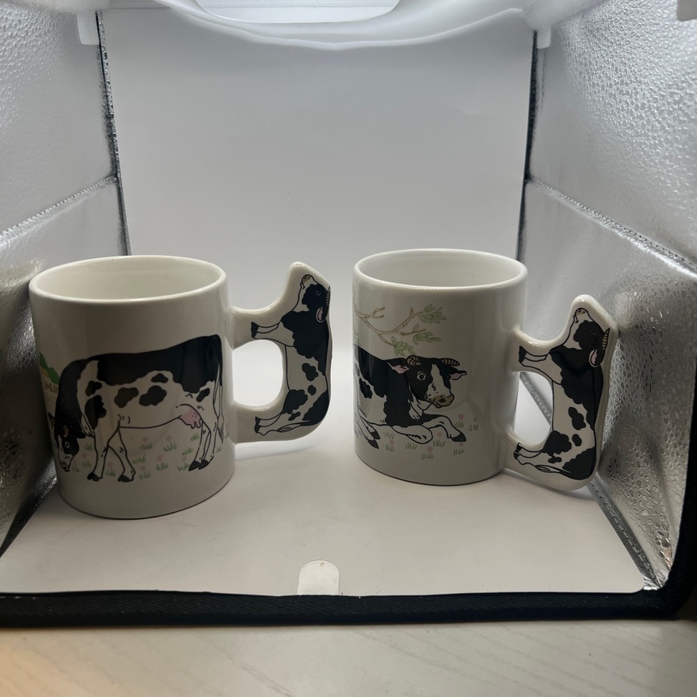 2 adorable cow coffee mugs with cow shaped handle.
